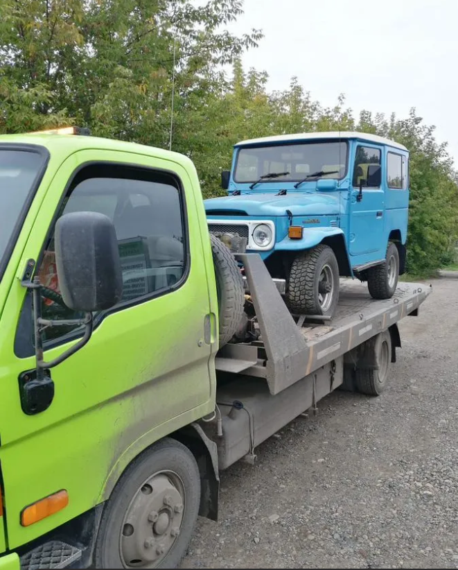 Prime Heavy Duty Towing transporting a vehicle on a flatbed tow truck in Fort Worth TX